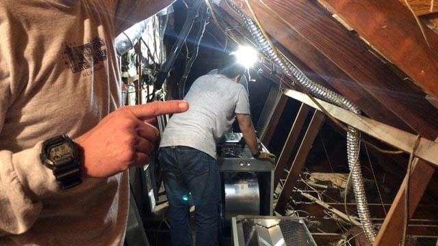 Technicians work to improve air flow in this customer's home