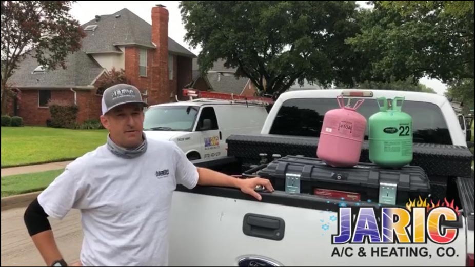 Owner Jim Richmond standing by his truck with two canisters of freon