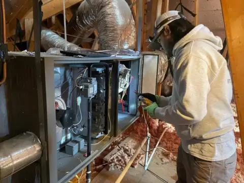 Technician quickly repairing a customer's HVAC issue.