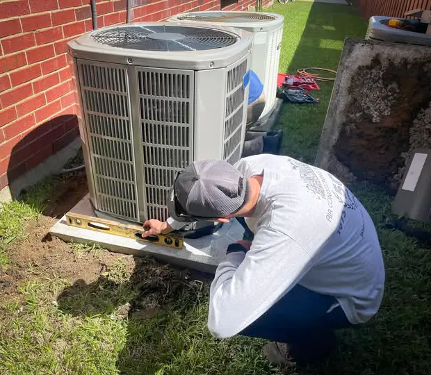 Jaric technician measuring to ensure the concrete slab is perfect.