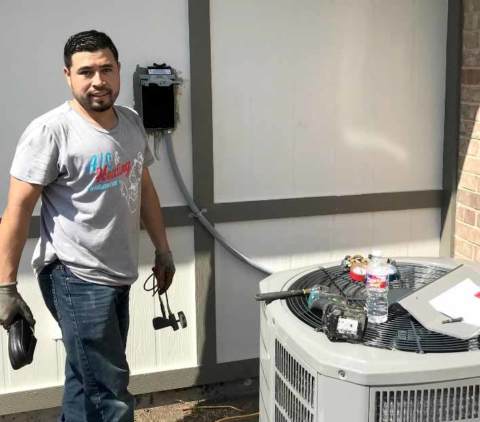 One of our techs working on a customer's air conditioner.