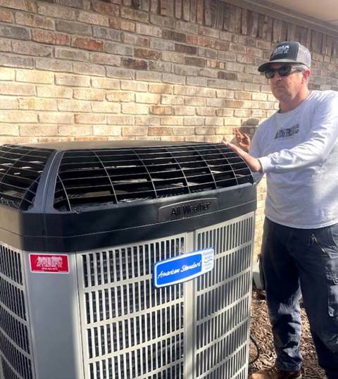 Working hard to ensure the proper installation of an American Standard air conditioner.